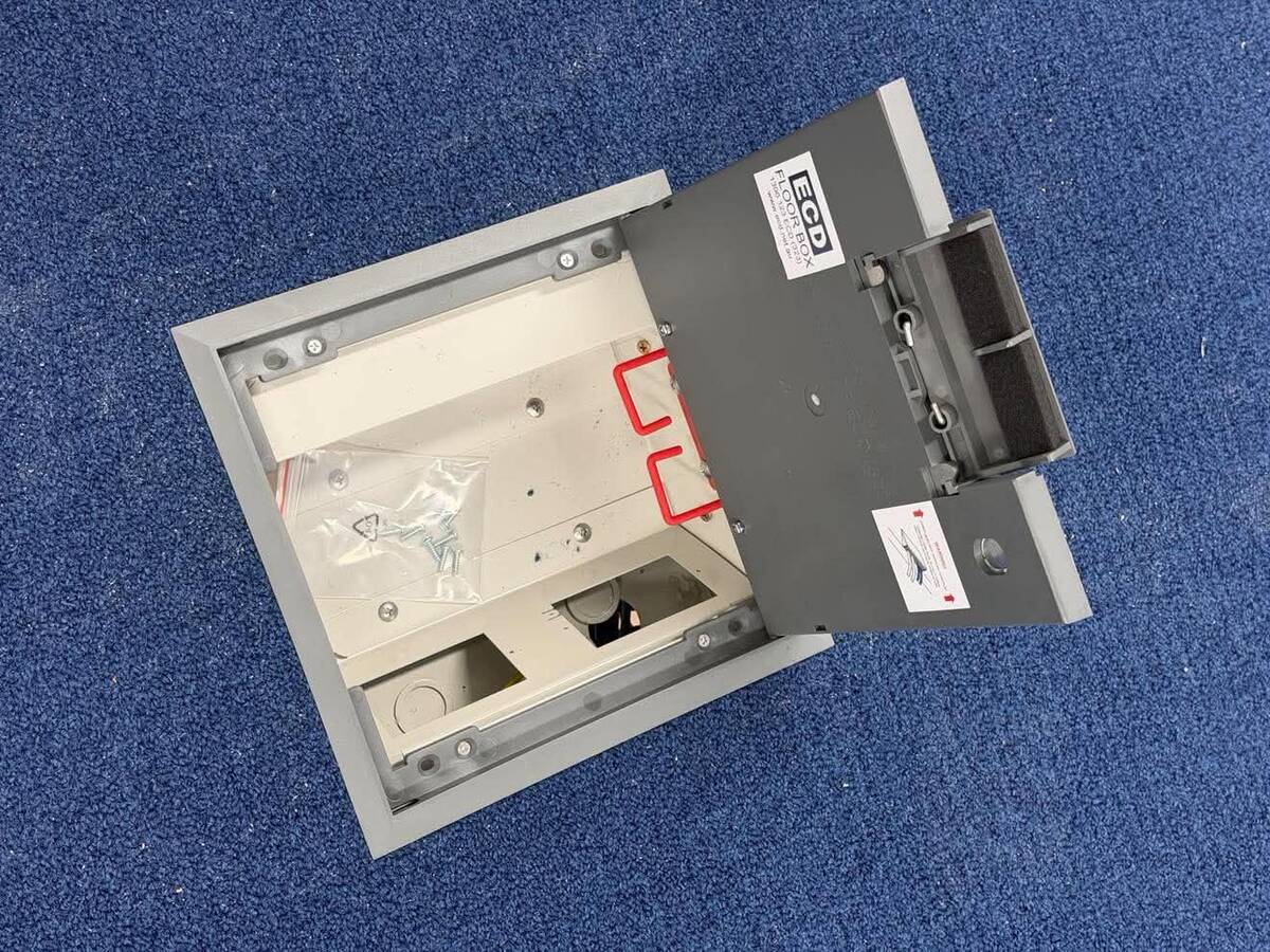 Open office floor box with power and data outlets set into the carpet