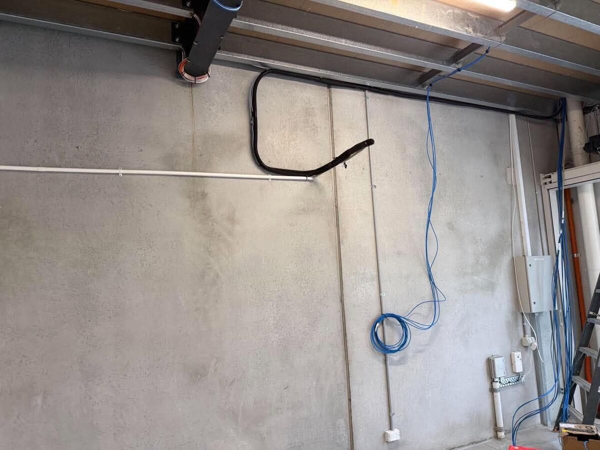 Warehouse wall with conduit and data cabling